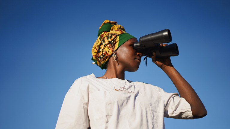 woman looking through binoculars